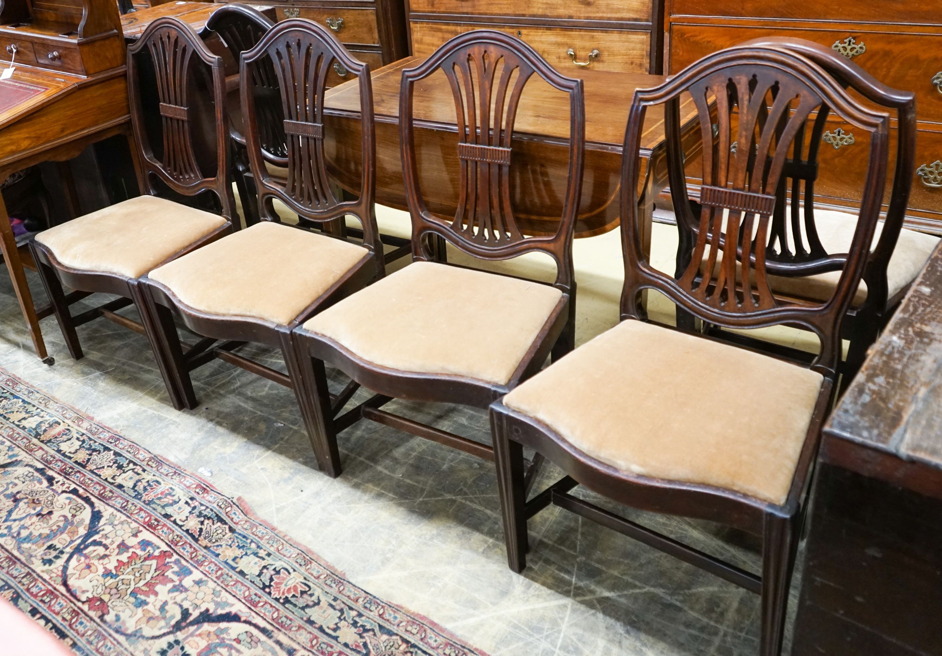 A set of six George III mahogany dining chairs (one with arms)